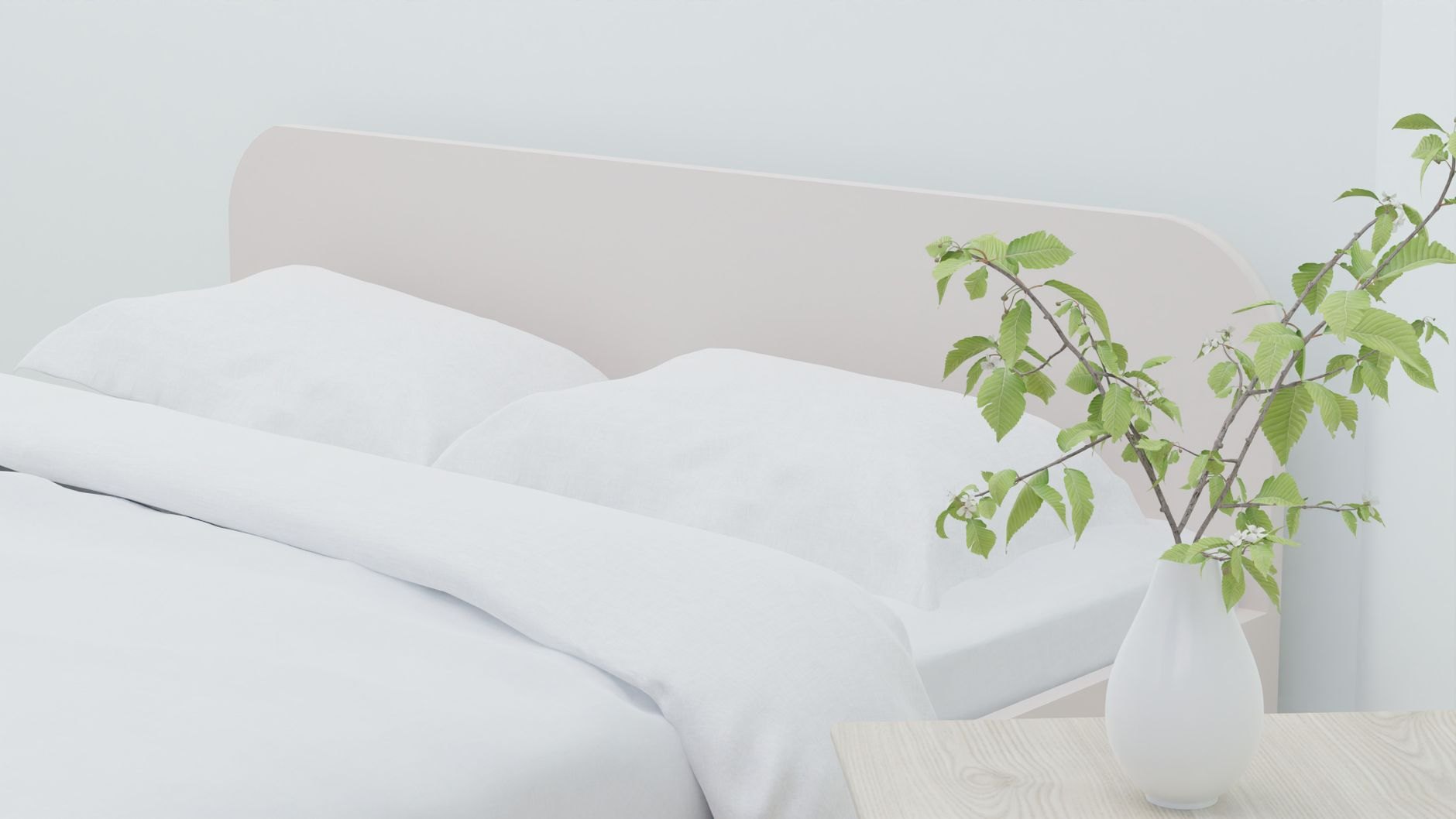 A bedroom with white bedding, a plant and daylight from the side