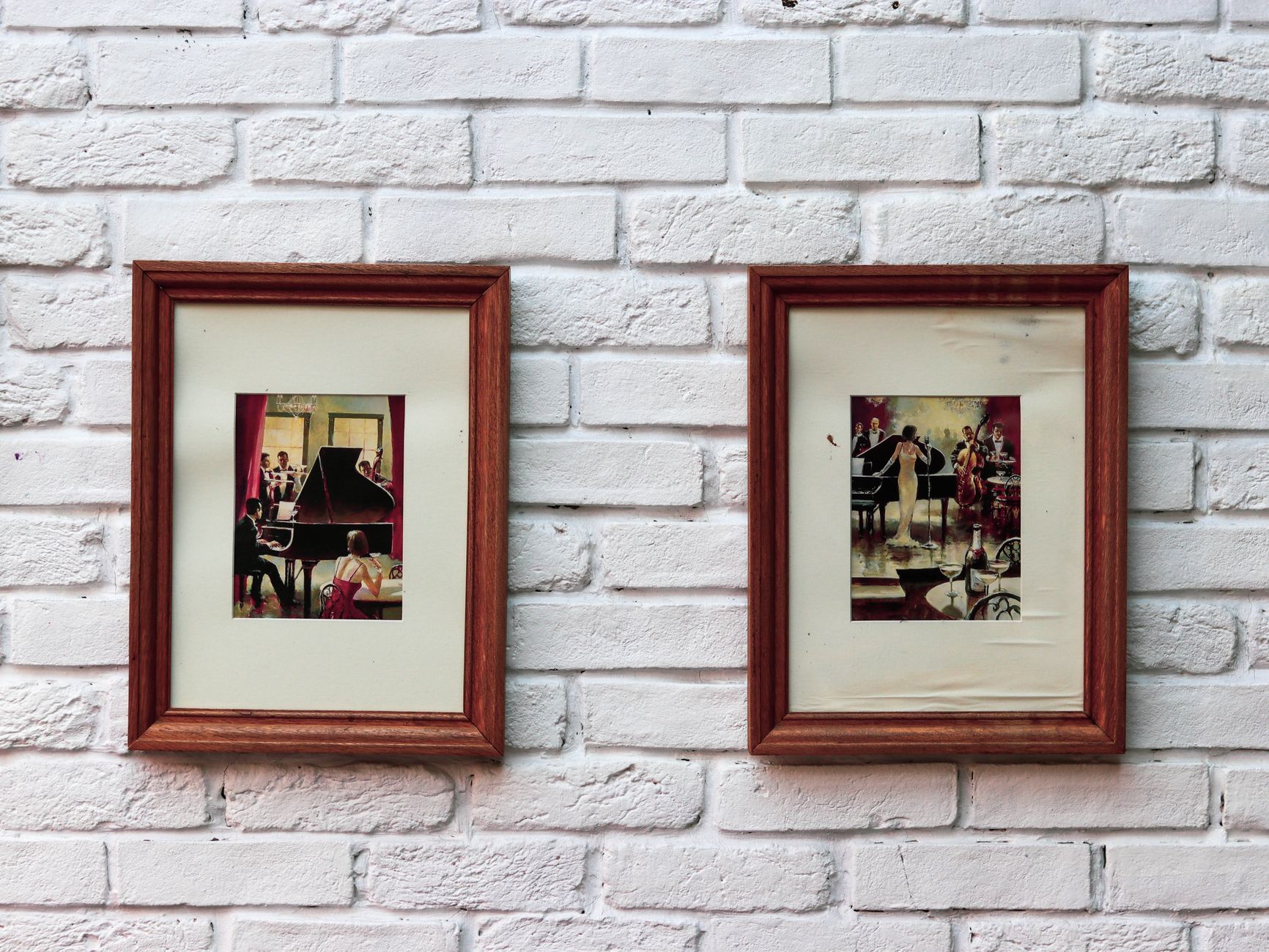 Two framed artworks on a textured white brick wall, creating a nostalgic aesthetic, illustrating What Does Feng Shui Say About Artwork and Its Subject