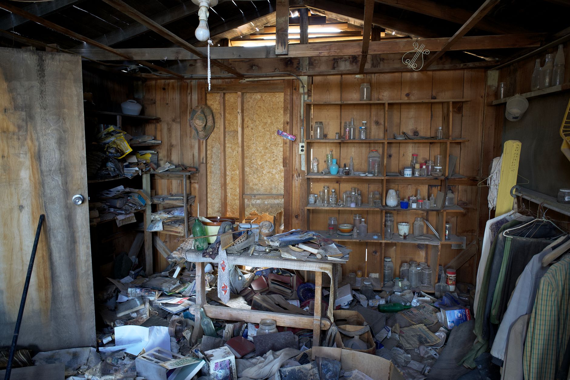 Interior view of an abandoned room filled with dusty and disorganized items, typical of urban decay, illustrating Why Is 'Buy This Lucky Object' Bad Feng Shui Advice