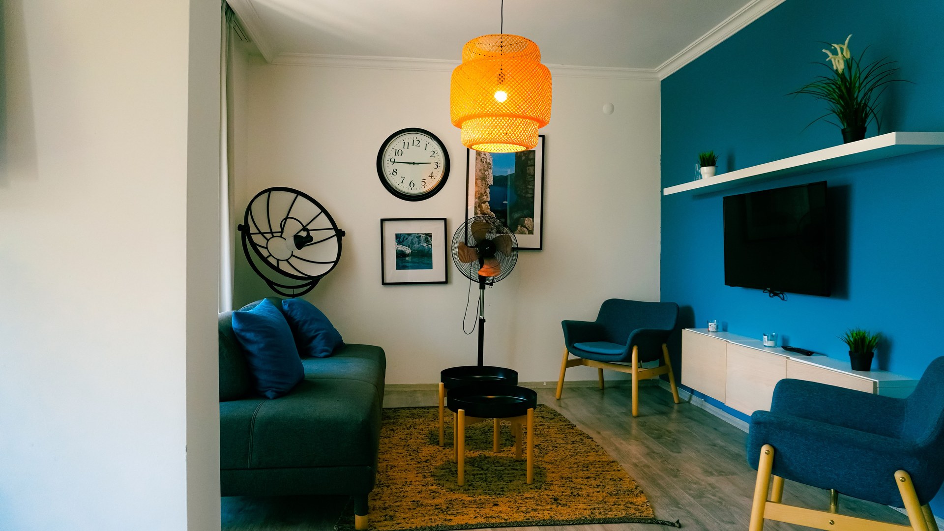Living room featuring contemporary furniture, blue accents, and a warm ambiance