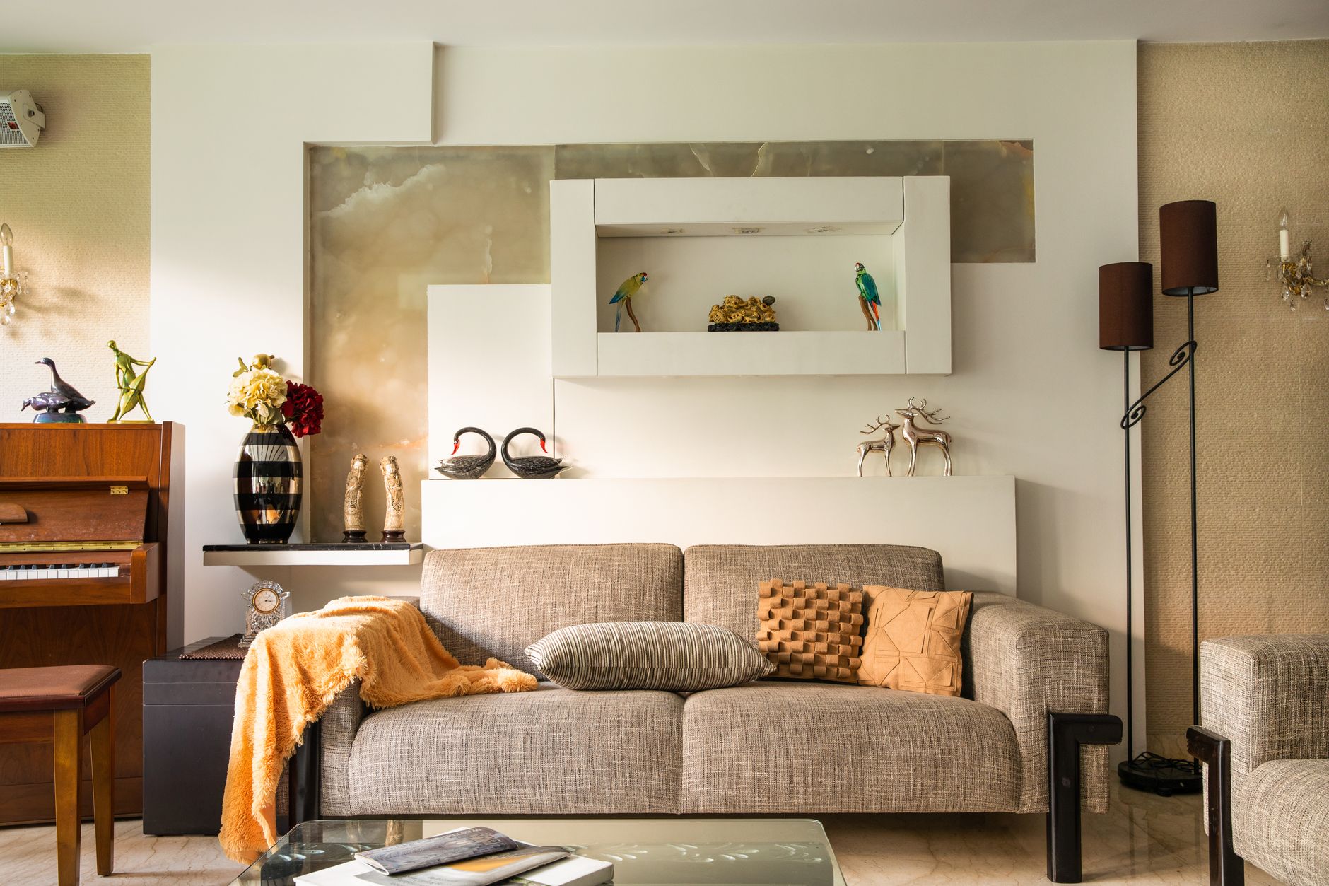 Cozy living room featuring a sofa, decorative items, and a piano, perfect for a stylish home interior, illustrating What Is a “Command View” of a Room? Feng Shui Guide