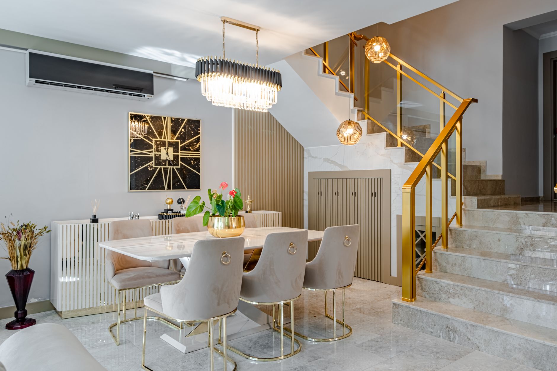 Modern dining room with marble table, gold accents, and stylish lighting, illustrating Where Should a Dining Room Mirror Go? A Feng Shui Guide