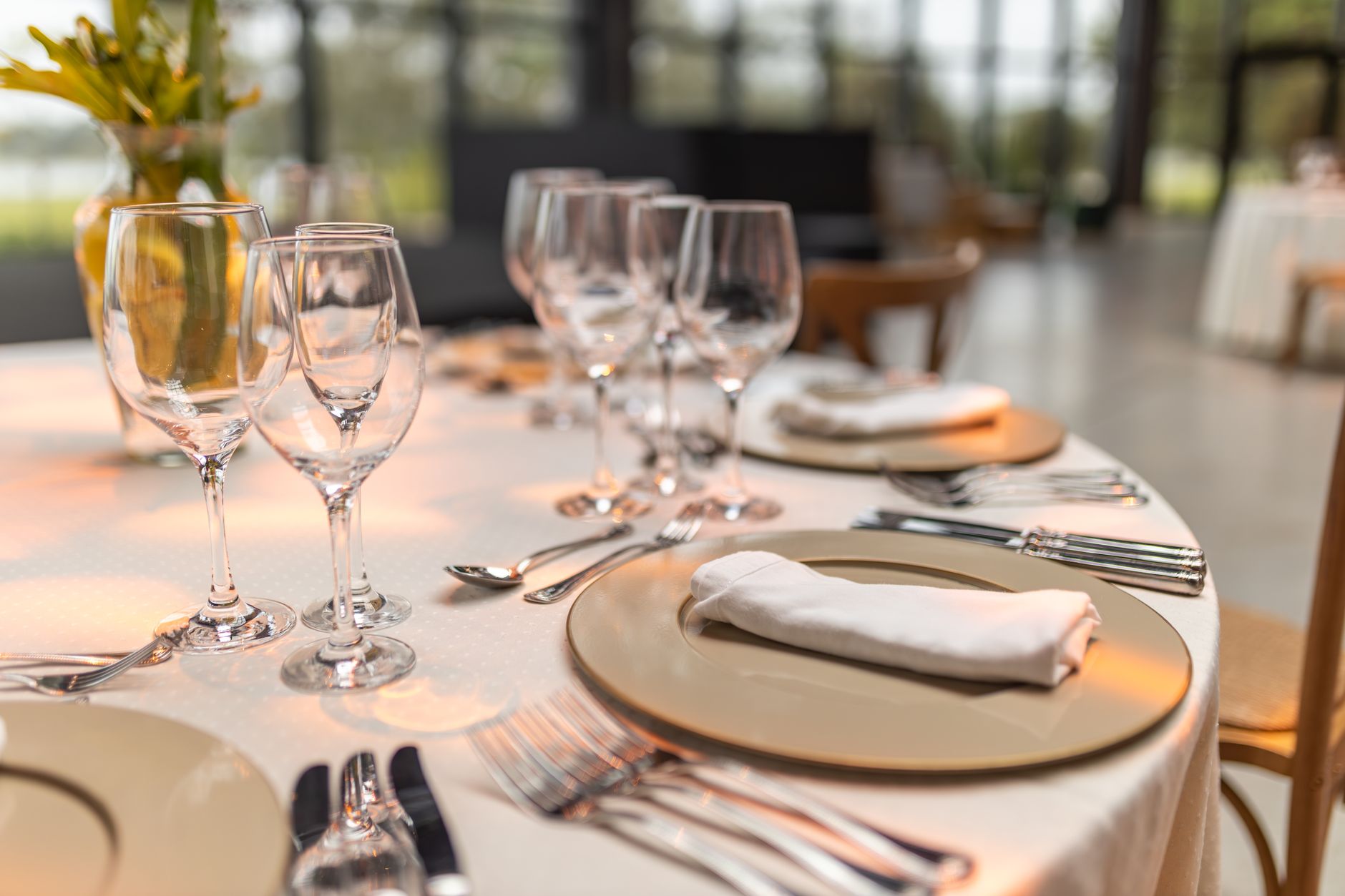 Sophisticated table setup with glassware and napkins for fine dining experience, illustrating What Does Feng Shui Say About a Dining Table's Shape