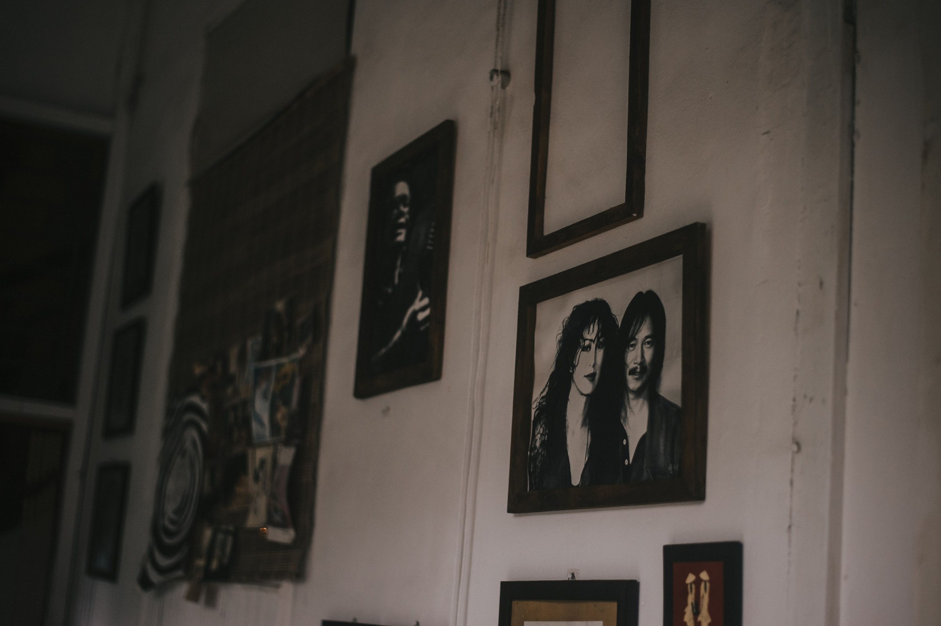 Room featuring wall art with black and white portraits, creating a stylish ambiance