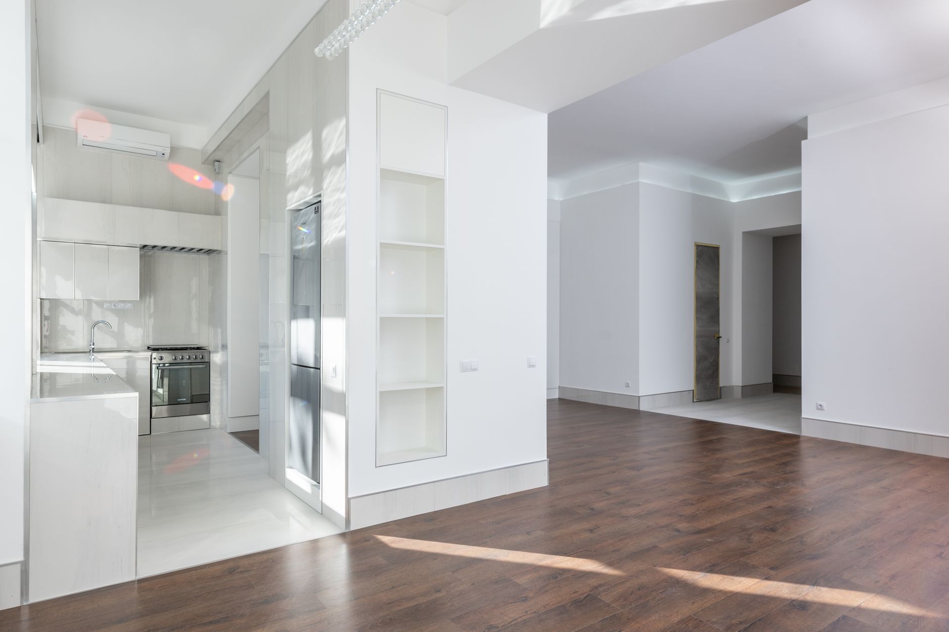 Spacious modern interior featuring an open kitchen and living area with elegant wooden flooring, ideal for contemporary homes, illustrating What Feng Shui Says About Moving In, and