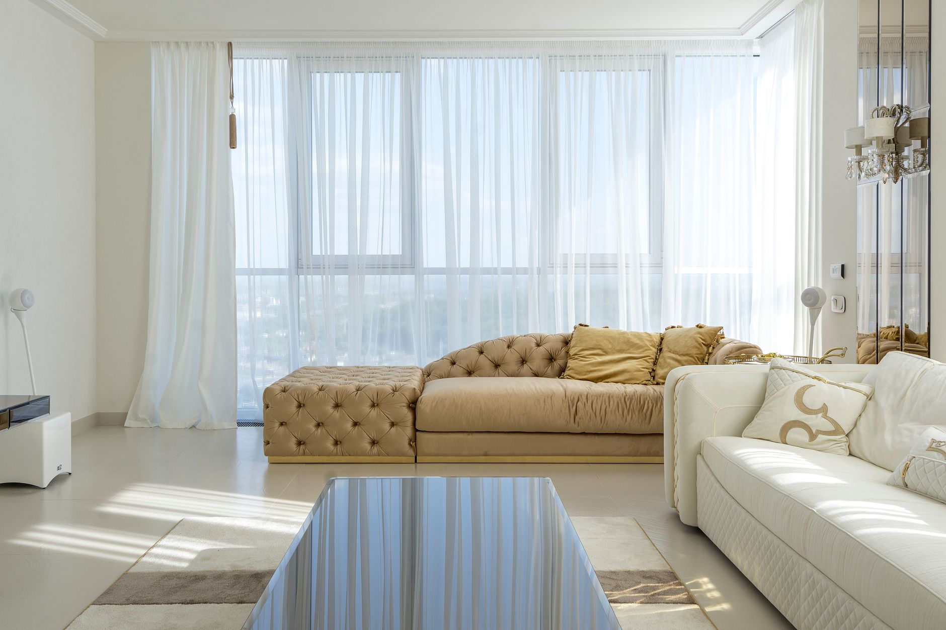 Stylish interior of living room in modern apartment with white and beige comfortable sofas, illustrating Form School vs Compass School Feng Shui: The Difference