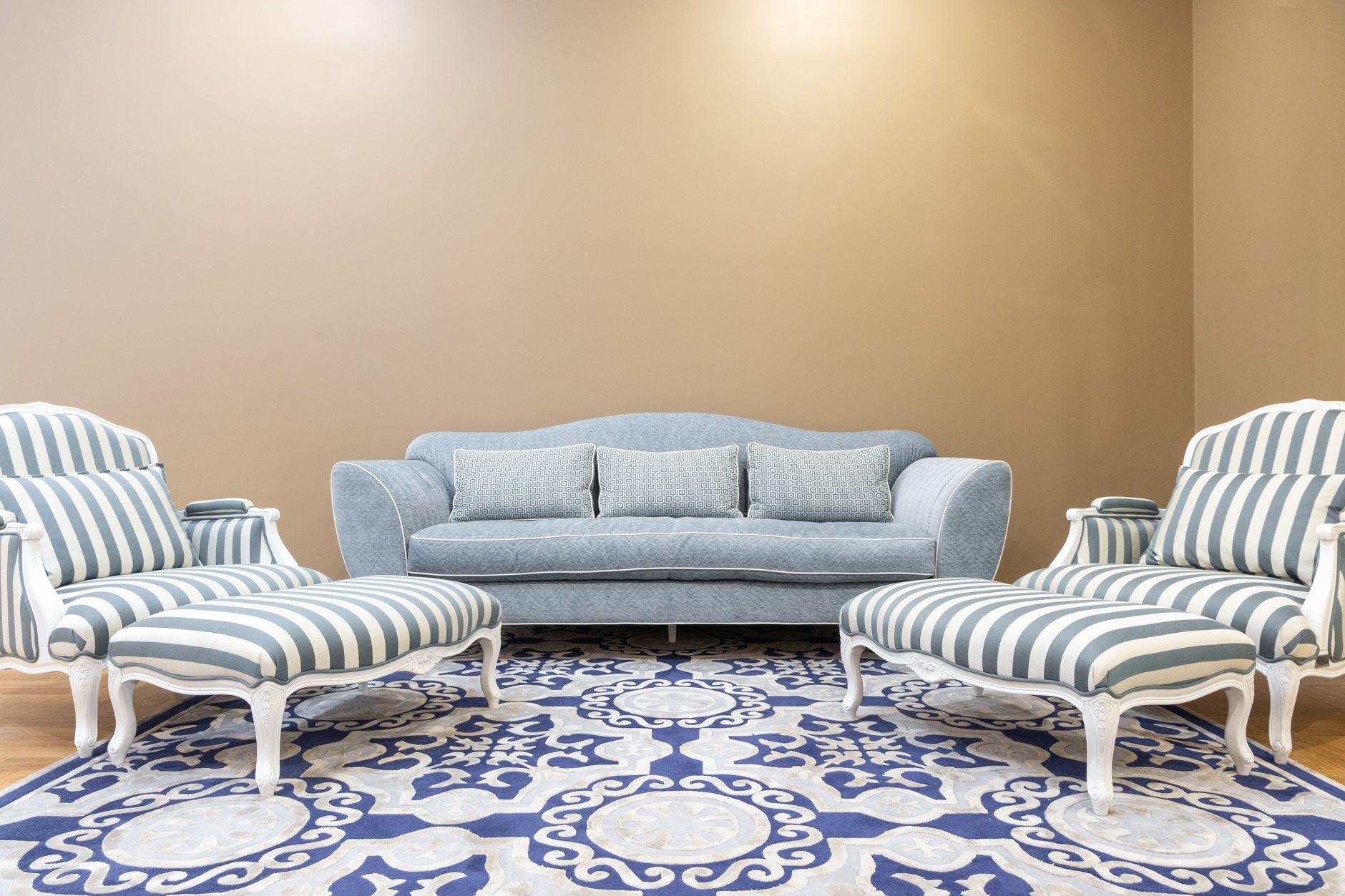 Luxurious living room interior featuring a vintage blue sofa and striped chairs on a patterned carpet, illustrating What Does Feng Shui Say About Furniture Height