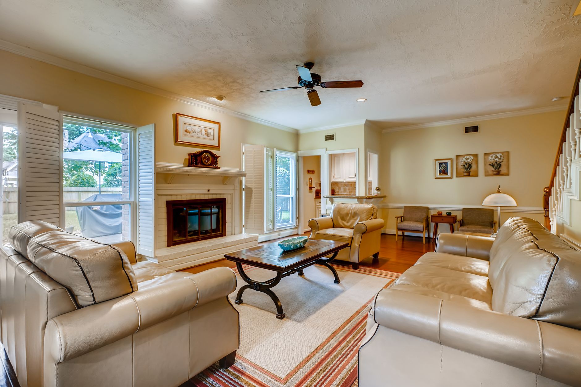 Spacious living room featuring comfortable sofas and chic decor in a well lit interior, illustrating How Does Furniture Placement Affect Circulation in a Home