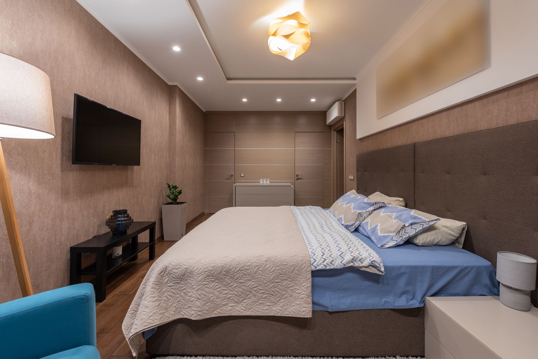 Elegant modern bedroom featuring a stylish bed, ambient lighting, and cozy decor, illustrating What Does Feng Shui Say About a Guest Bedroom