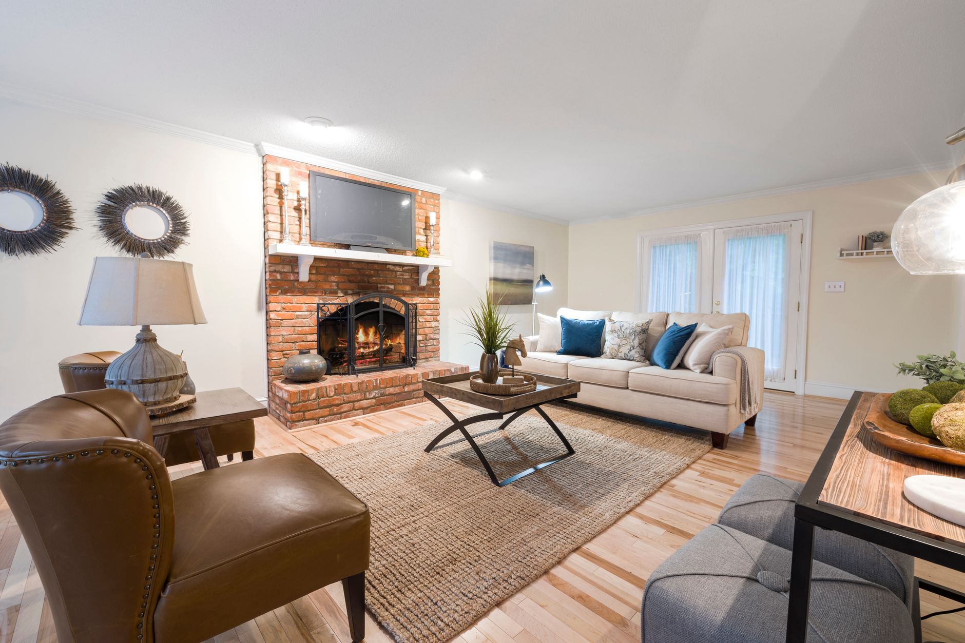 Inviting living room featuring cozy seating, brick fireplace, and stylish decor, illustrating How Should a Living Room Be Arranged for Conversation