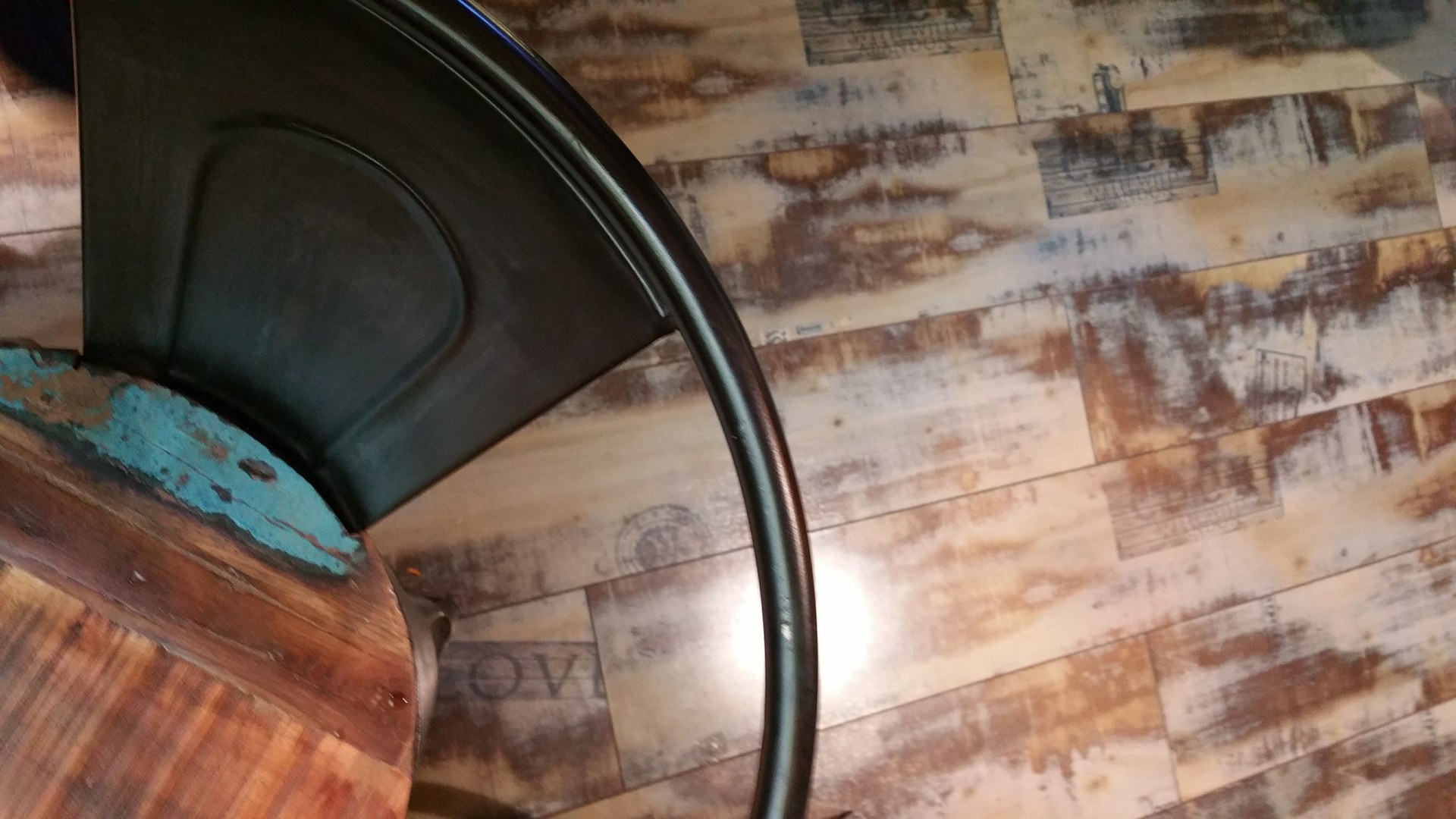 A rustic wooden table and industrial chair pair with wooden flooring