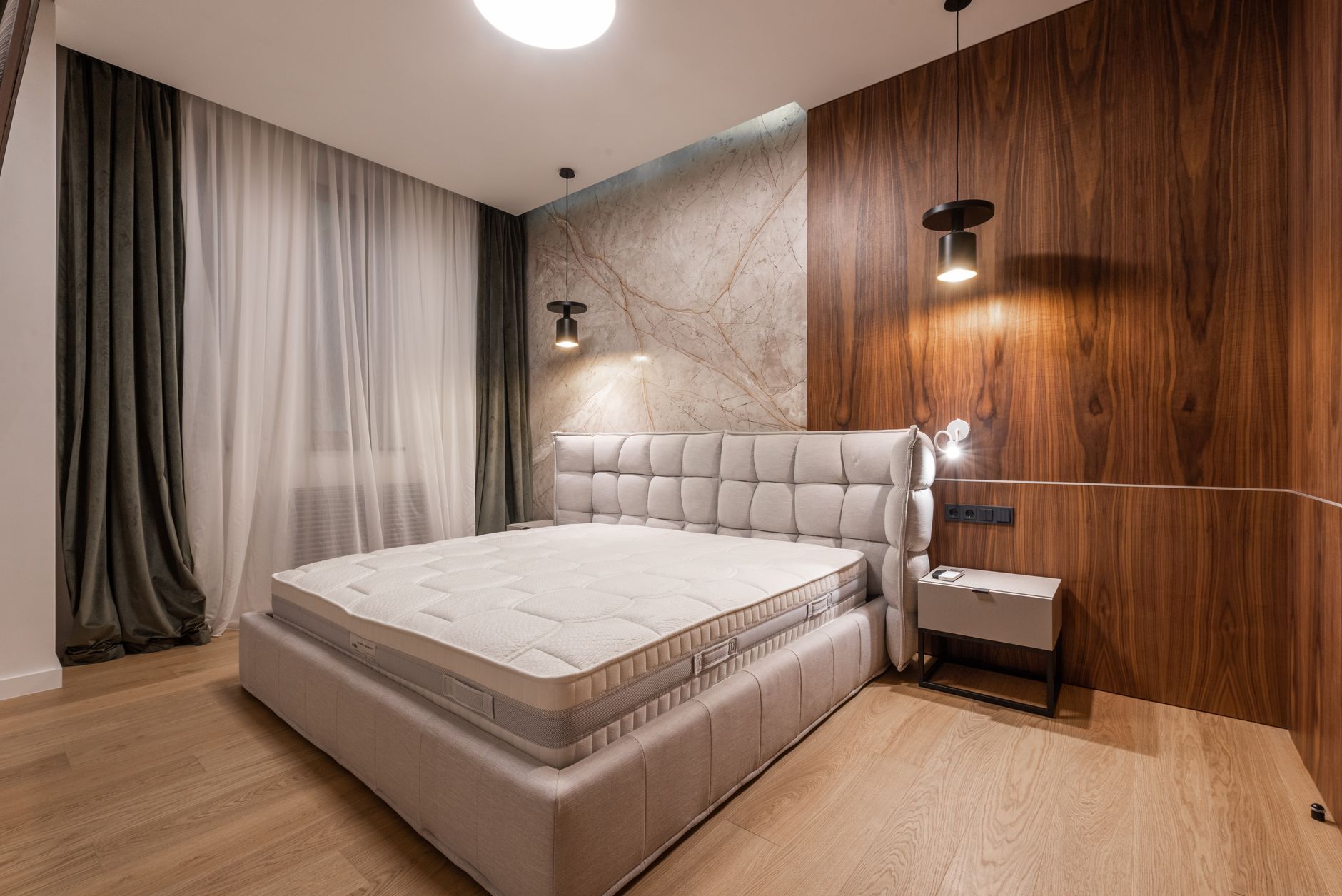 Comfortable soft empty bed placed in stylish modern bedroom in contemporary apartment in minimalistic style, illustrating The Most Common Feng Shui Mistake in a Bedroom