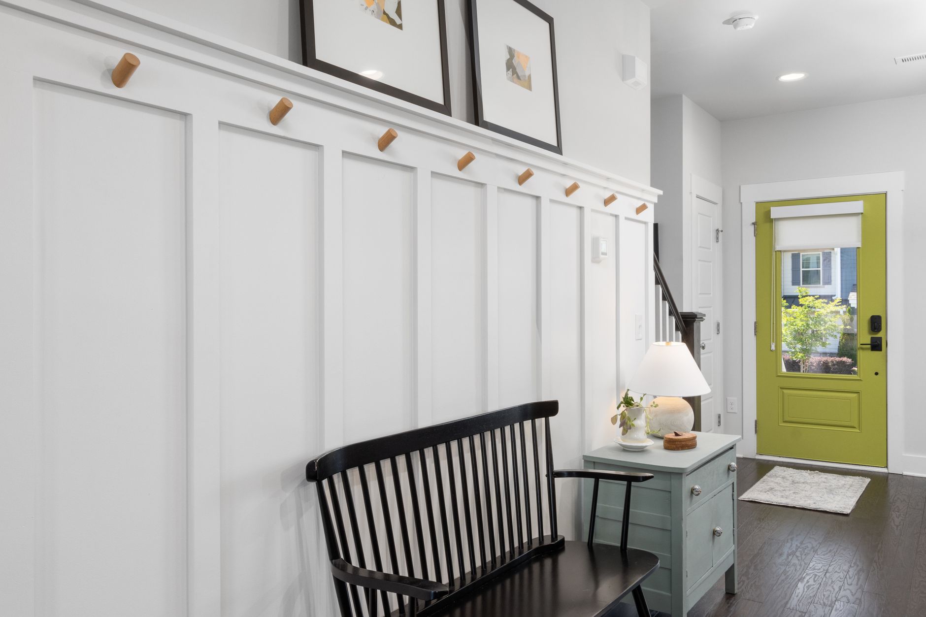 Stylish entryway featuring a green door, black bench, and decorative elements, illustrating No Entryway at Home: What Feng Shui Actually Says