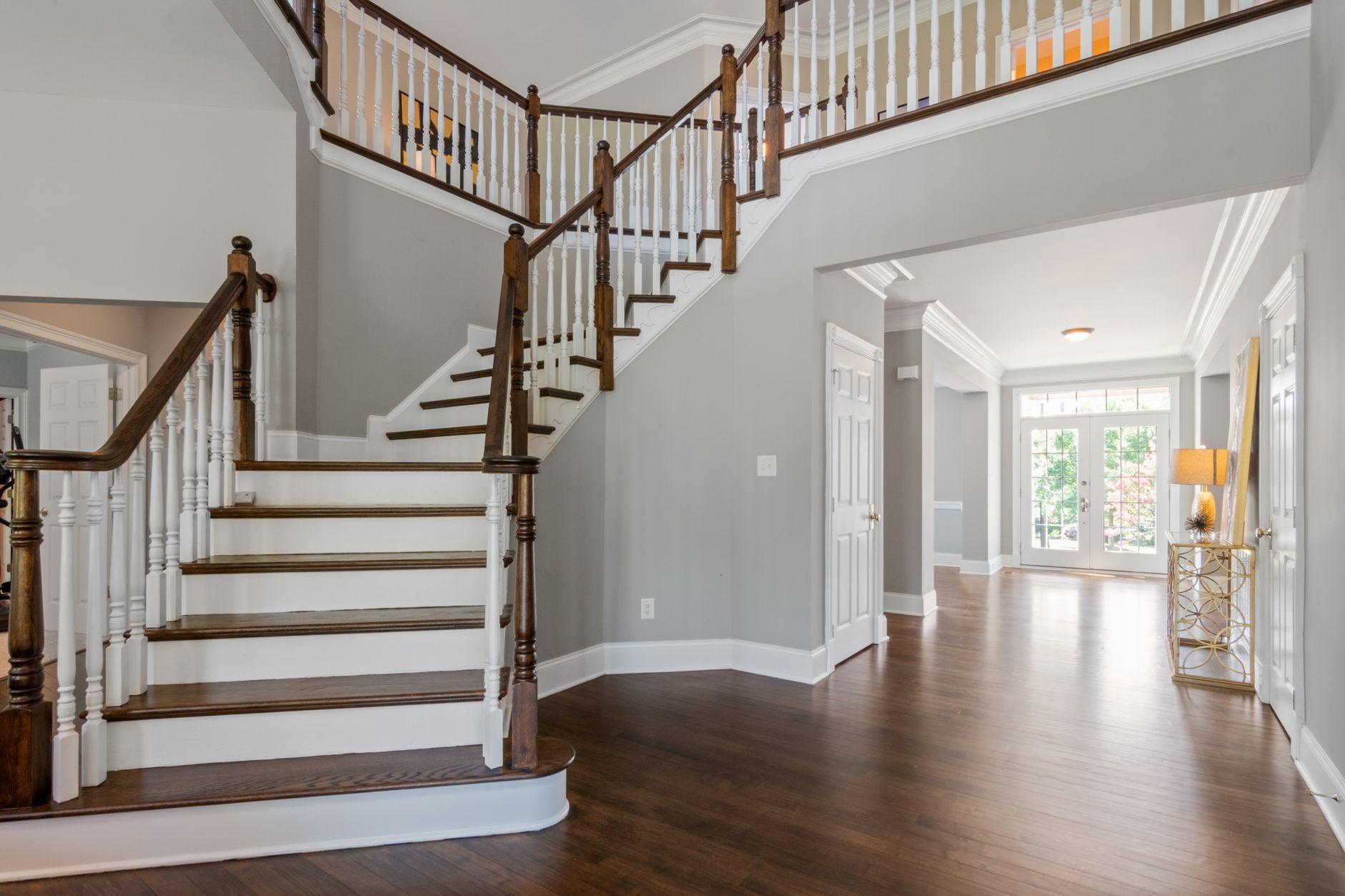 Bright and spacious entryway with wooden staircase and natural lighting, illustrating No Entryway at Home: What Feng Shui Actually Says