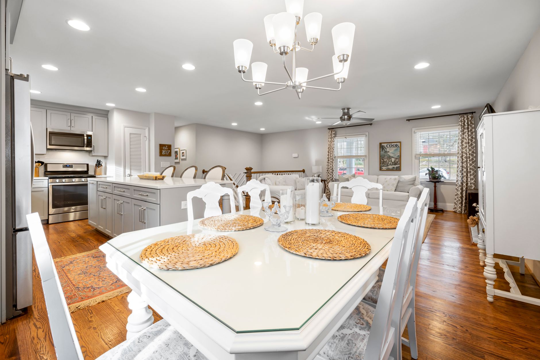 Stylish open plan kitchen with dining area, showcasing modern interior design and warm lighting, illustrating How Should an Open-Plan Space Be Divided? Feng Shui Guide
