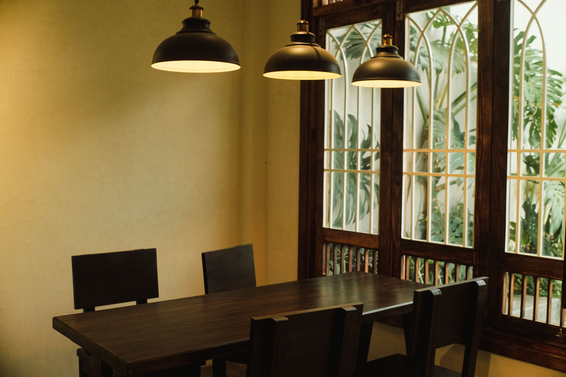Dining area in Dalat, Vietnam featuring wood table, chairs, and pendant lights