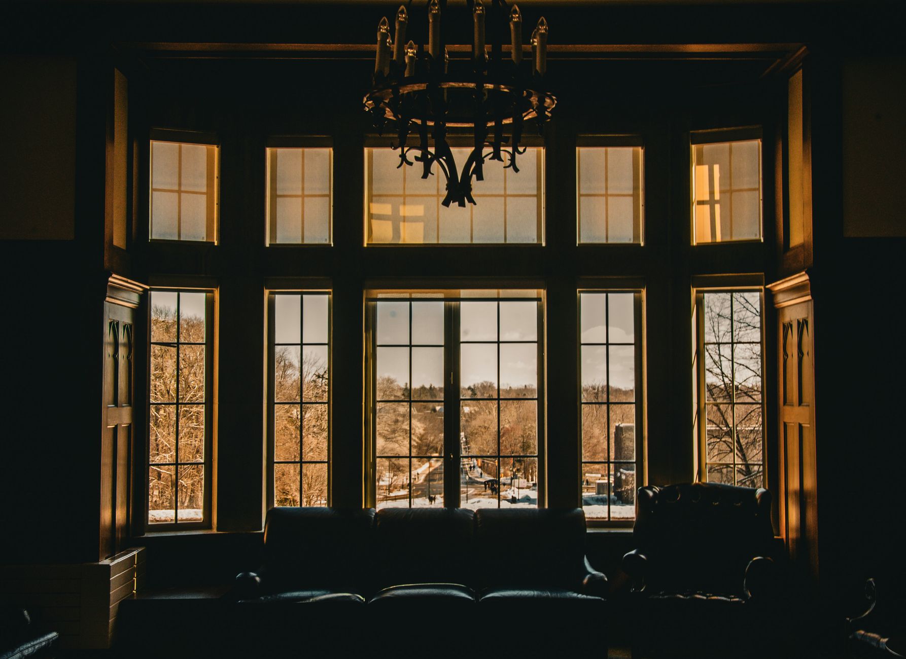 Warm interior with large windows overlooking a scenic outdoor view, illustrating What Does Feng Shui Say About a Room With No Window