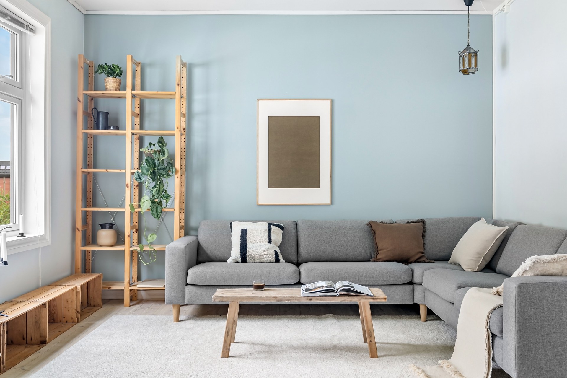 Scandinavian living room with modern gray couch and wooden elements