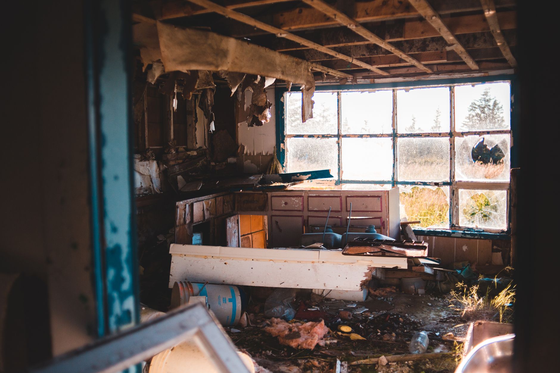 Interior of abandoned ruined building with broken window and damaged furniture with trash on floor in daylight in countryside inside, illustrating What to Ignore in Most Online Fen
