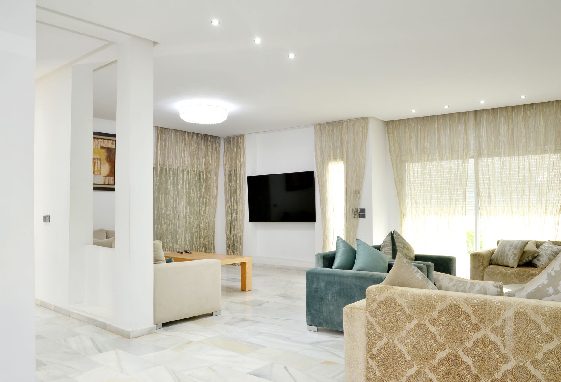 Spacious modern living room with elegant sofas and stylish decor, illustrating Where Should a Sofa Go in a Living Room? Feng Shui Guide