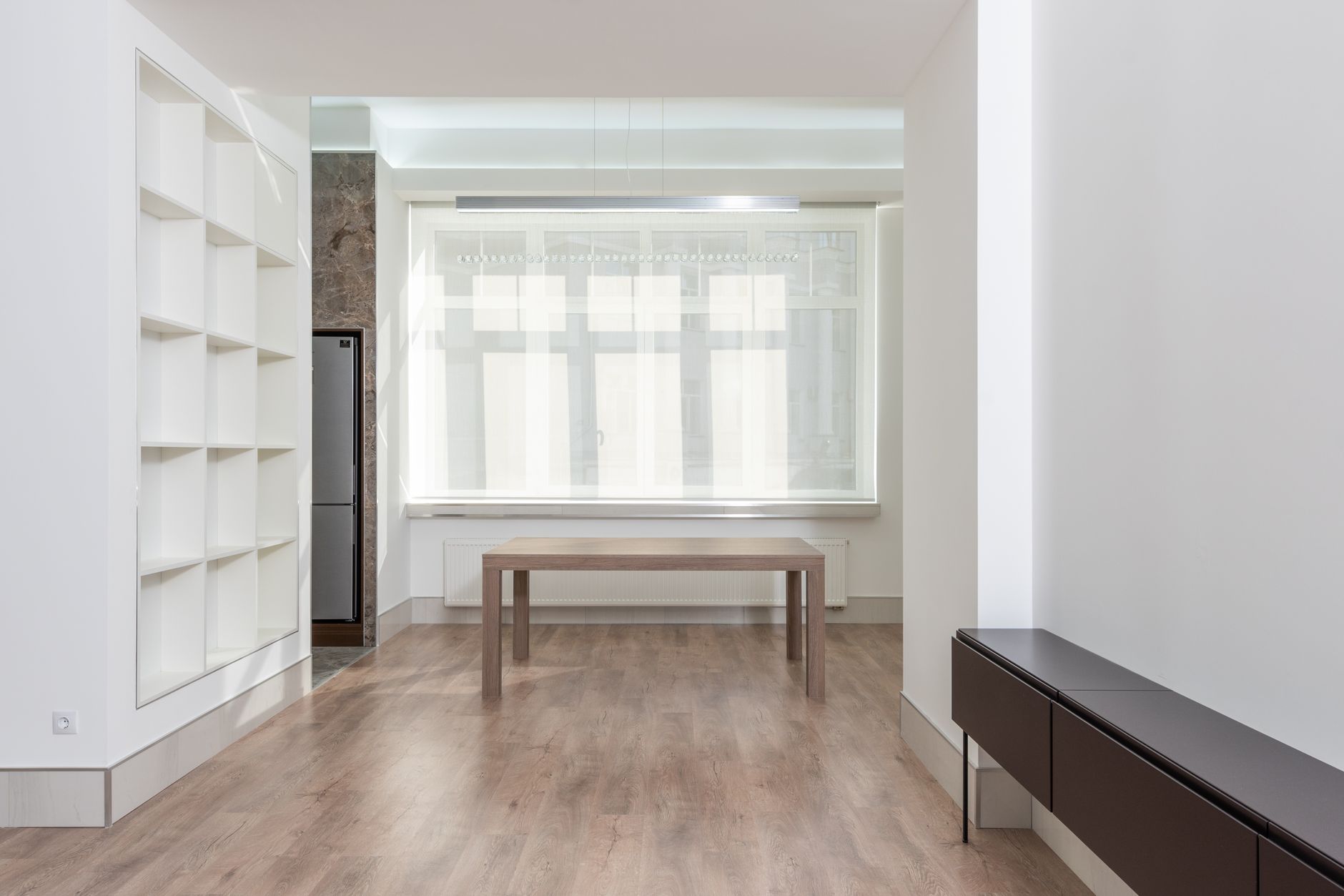 Bright minimalist living room interior with wooden flooring and simple furniture, illustrating Why Do Feng Shui Consultants Disagree With Each Other