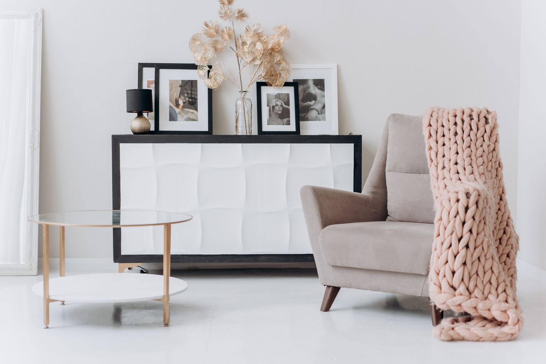 A cozy, contemporary interior setup with a beige chair, soft decor, and elegant furnishings, illustrating Why Do Feng Shui Rules Contradict Each Other So Often