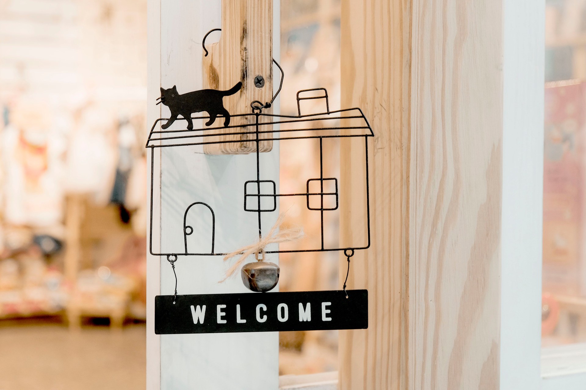 Interior design wooden door decoration featuring a welcome sign with cat silhouette